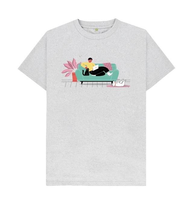 A light grey t-shirt with an illustration across the chest. The illustration features a person on a couch with a cat, a dog belly-up on a rug, and a plant.