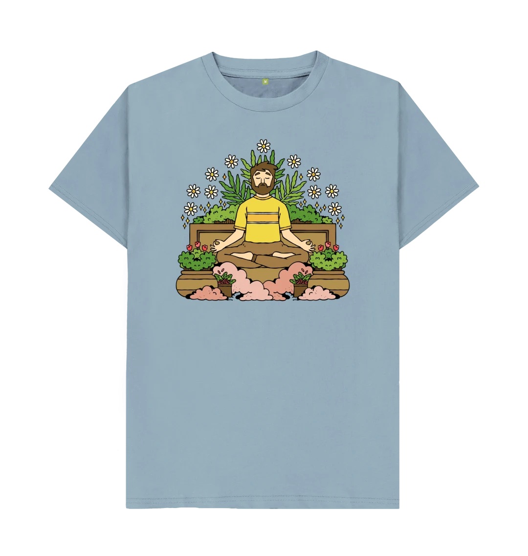 A light blue t-shirt with an illustration across the chest. The illustration features a person in a meditation pose surrounded by plants.